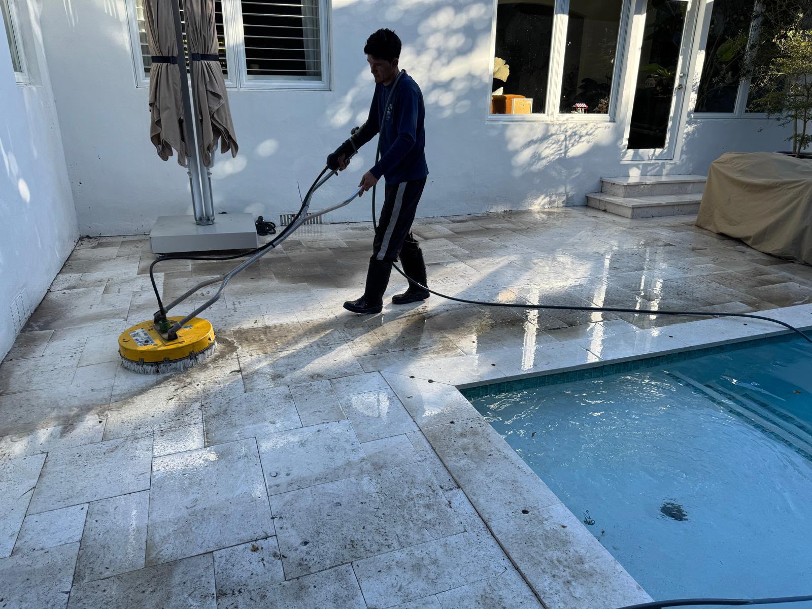 UDS technician using a surface cleaner on a South Florida property